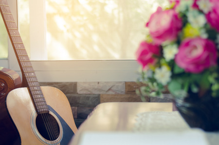 book and yellow pen on table with guitar backgroundの写真素材