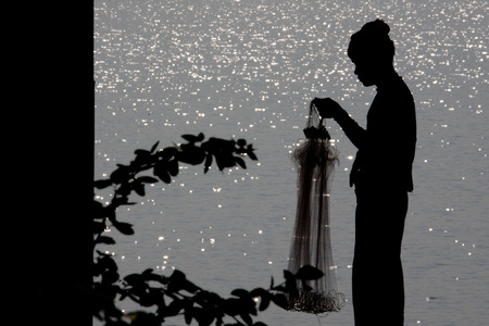 Fisherman in silhouetteの写真素材