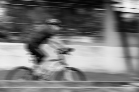 Ride the bike in the park in motion blur in black and white modeの写真素材