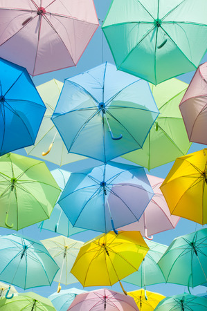 A lot of multicolored umbrellas over the skyの写真素材