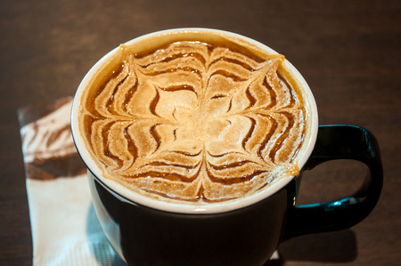 Cup of Caramel Latte Coffee with paper napkinの写真素材