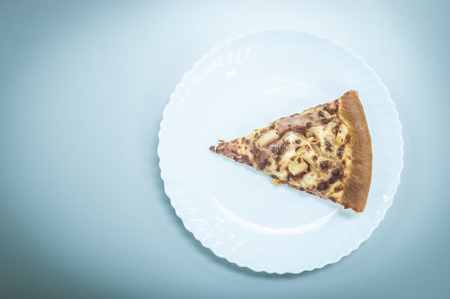 Vintage tone of a piece of Pizza on white plateの写真素材