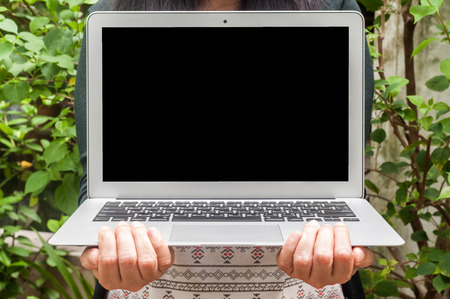 Blank background laptop on woman's handの写真素材