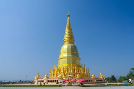 The gold pagoda under clear sky located at north of Thailandの写真素材