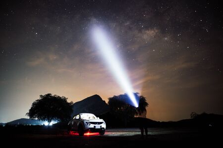 Night sky of milky way with car and camping tent in front of mountain backgroundの写真素材