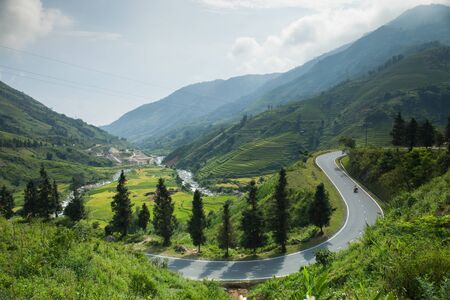 Curve of road across mountain view with rice terrance on hill background location at SAP north of Vietnamの写真素材
