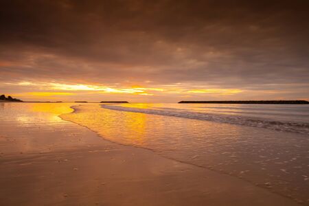 Sunrise is reflection on beach at ocean in Tropicana country location at south of Thailandの写真素材
