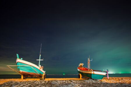 Long tail boat parking on beachの写真素材