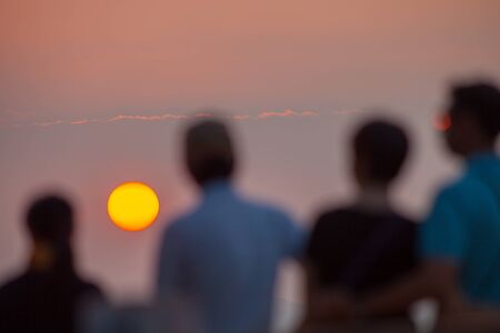 Beautiful sunset landscape in-font of people with cloudyの写真素材