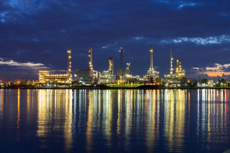 Oil refinery industry reflection on water under cloudy sky at morning time location at Bangkok...