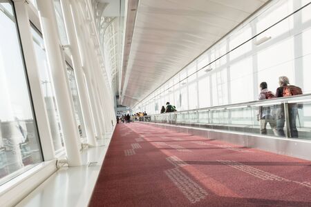 Blur of passengers walking in airport walkway location at Japanの写真素材