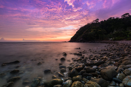 A twilight time after sunset on beach with stone foreground