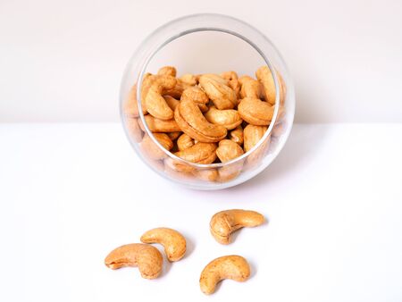cashew nuts in glass bowl isolated on white background.の写真素材