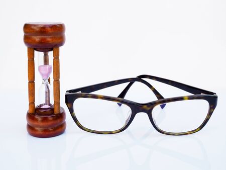 Hourglass and glasses isolated on white background, Count down of timing to take care of health of...