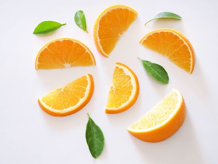 Top view of fresh orange and piece sliced with green leaves isolated on white background.の写真素材