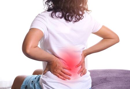 Young asian woman massaging on waist to relax muscle with back pain and muscle inflammation. Sick...