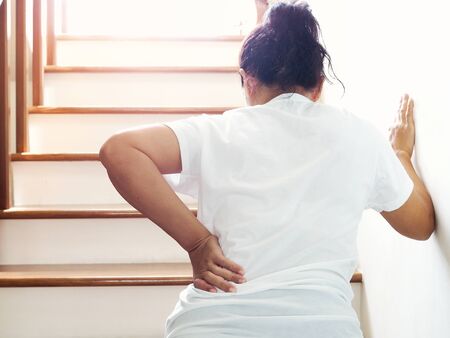 Young Asian woman suffering with back pain symptom waist pain and office syndrome disease.