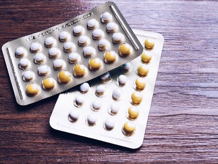 Contraceptive pill panel, birth control pills on wooden table.の写真素材