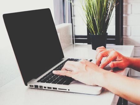 working people use laptop computer to work on white desk, investment workspace or work from home.の写真素材