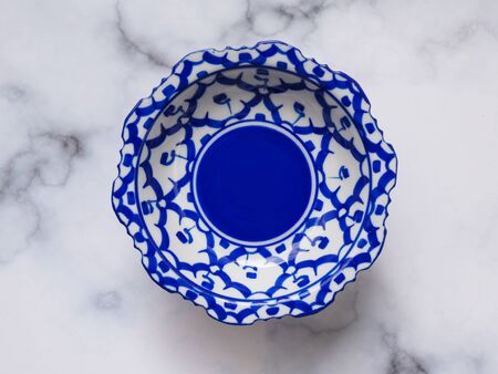Top view of blue porcelain ceramic plate, pottery thai style isolated on white background.の写真素材