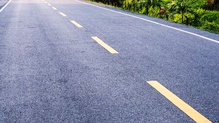 Path on the way, dash symbol line on asphalt road in Asian countryside of Thailand.