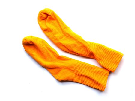 Pair of old yellow sports socks isolated on white background.の写真素材