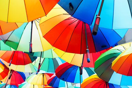 close-up of colorful umbrella, background with rainbow color red, blue, green, yellow, and orange, colors of seasonの写真素材