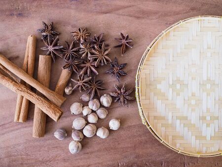 Dried herbs and spices with star anise, cinnamon sticks, amomum testaceum or siam cardamom and copy...
