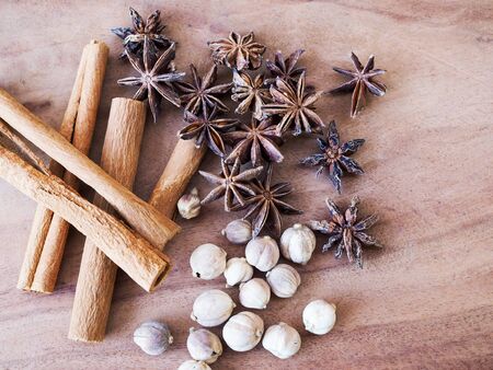 Dried herbs and spices on wooden table.