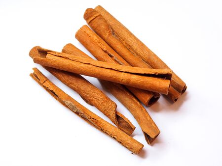 Herbs and spices with cinnamon roll sticks isolated on white backgeound.の写真素材