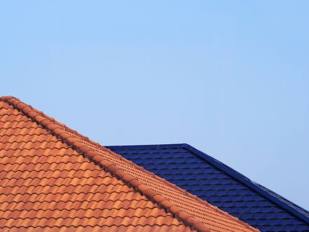 On top roof of house from clay tiles of Asian building with blue sky is background.