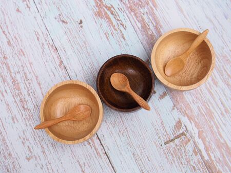 Top view set of wooden spoon and wooden cup bowl on tableの写真素材