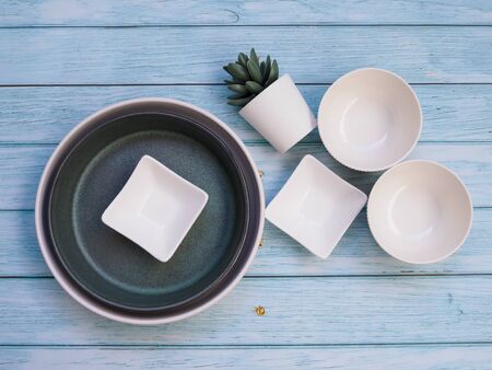 Top view of white ceramics tableware with bowl plate or round dish and crockery set on wooden table.の写真素材