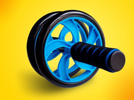 Exercise roller ab wheel training isolated on yellow background for strengthening muscles Keep fit...