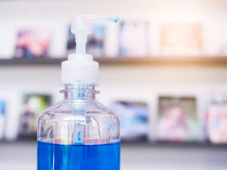 cleaning hand Alcohol gel sterilizing solution in library room, New normal Concept.