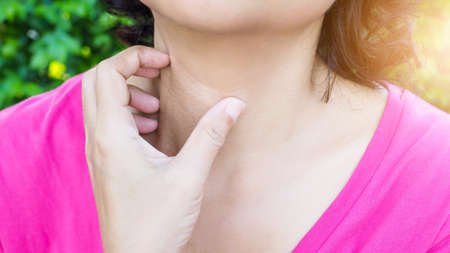 Asian women use hands to scratching on neck to relieve itching, Skin problems and rash with dry...