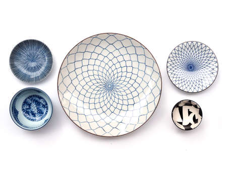 Top view of round ceramic plate set, tableware blue dish isolated on white background.