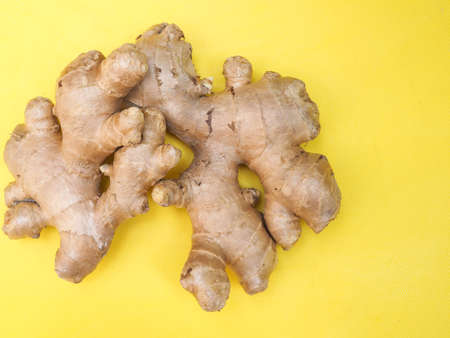 Top view of ginger isolated on yellow background.