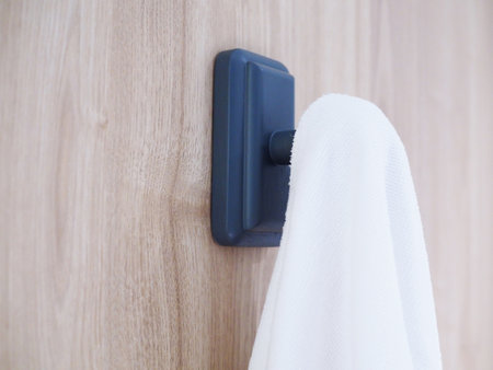 Wooden hanger hook with white towel on cloth hanger.の写真素材
