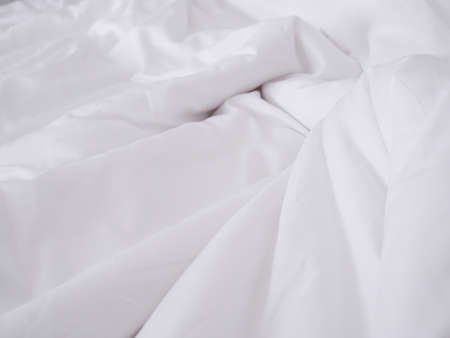 Background with wrinkled crumpled blanket duvet on bed.
