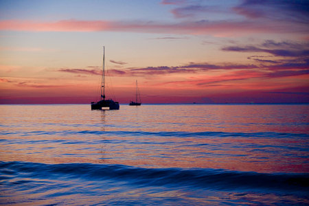 Sunset on the beach with shipの写真素材