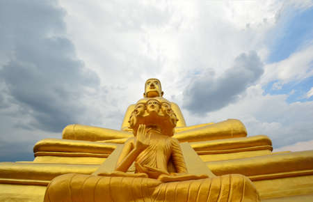 Large golden Buddha surrounded by clouds.