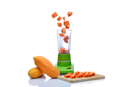 Blender is spinning papaya on white backgroundの写真素材