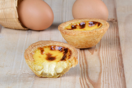 Close up bite egg tart on floor wooden
