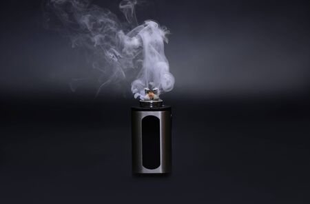 Electric cigarette in smoke on dark backgroundの写真素材