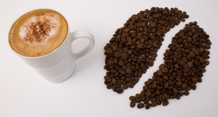 Coffee cup with beans arranged at sideの写真素材