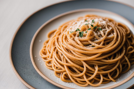 Spaghetti pasta with parmesan cheese and parsley on a plateの素材