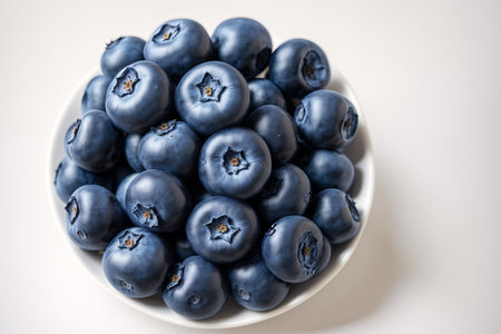 Blueberries in a bowl on a white background. Toned.の素材
