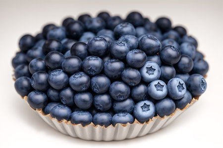 Blueberries in a bowl on a white background. Close-up.の素材