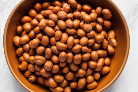 Close up of roasted hazelnuts in a bowlle backgroundの素材